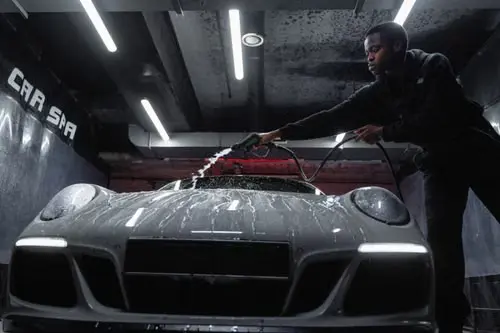 Front view of a premium sports car covered in detailing foam
