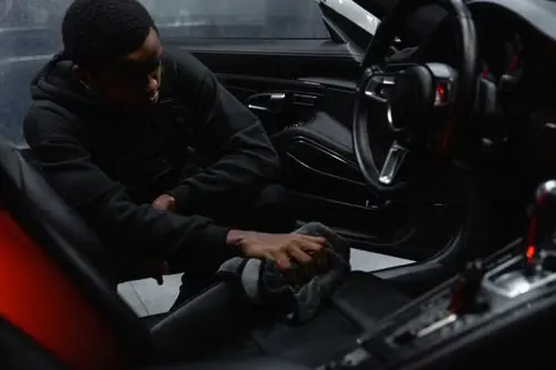 Hands-on interior detailing inside a premium vehicle